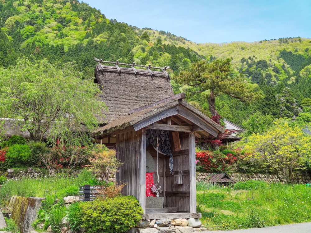 A Jizo statue placed by the roadside, watching over travelers.