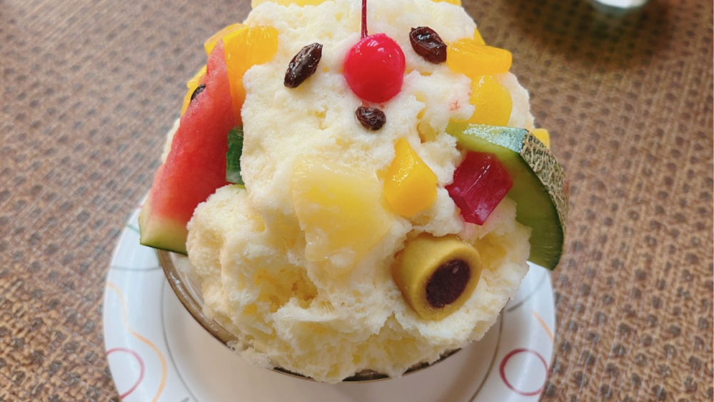 A close-up of shaved ice with colorful toppings
